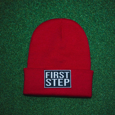Red Beanie with a First Step Apparel Patch Sewn on